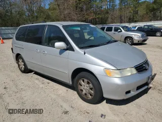 2004 Honda Odyssey EX-L with VIN 5FNRL18974B074613, listed as a Copart auction lot 48924865 with 212,633 mi miles and Salvage Title. Bid and sale history available at DreamBid. Image 4.