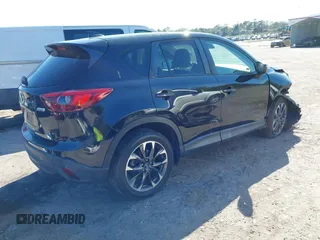 2016 Mazda CX-5 Grand Touring with VIN JM3KE4DY4G0677605, listed as a IAAI auction lot 41642893 with Not Provided miles and . Bid and sale history available at carsss.com. Image 4.