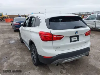 2019 BMW X1 xDrive28i with VIN WBXHT3C51K5L90392, listed as a IAAI auction lot 41571403 with 96,732 mi miles. Bid and sale history available at carsss.com. Image 3.