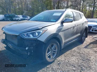 2018 Hyundai Santa Fe 2.4L z VIN 5NMZUDLB7JH077241, wystawiony jako IAAI lot #42135854 z przebiegiem 59 819 mil mil oraz . Historia ofert i sprzedaży dostępna na DreamBid. Obrazek 2.