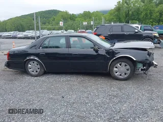 2002 Cadillac DeVille DTS z VIN 1G6KF579320288667, wystawiony jako IAAI lot #42331236 z przebiegiem 71 189 mil mil oraz . Historia ofert i sprzedaży dostępna na DreamBid. Obrazek 13.