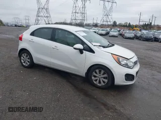 2013 Kia Rio SX with VIN KNADN5A34D6245263, listed as a IAAI auction lot 41976166 with 101,438 mi miles. Bid and sale history available at carsss.com. Image 1.