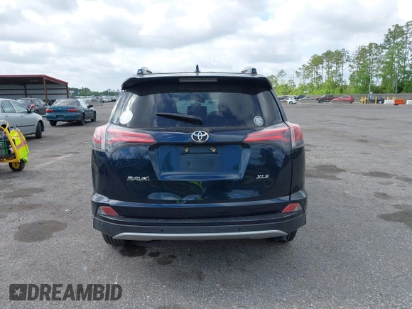 2018 Toyota RAV4 XLE with VIN JTMWFREV9JJ165655, listed as a IAAI auction lot 42138998 with 123,569 mi miles and . Bid and sale history available at carsss.com. Image 16.