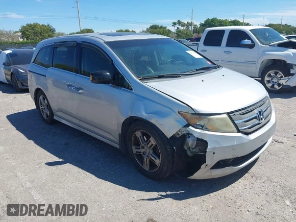 2012 Honda Odyssey Touring with VIN 5FNRL5H90CB099519, listed as a IAAI auction lot 41854550 with 185,110 mi miles. Bid and sale history available at carsss.com. Image 1.