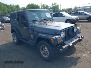 2001 Jeep Wrangler Sport z VIN 1J4FA49S61P369905, wystawiony jako IAAI lot #42439523 z przebiegiem 255 619 mil mil oraz . Historia ofert i sprzedaży dostępna na DreamBid. Obrazek 1.