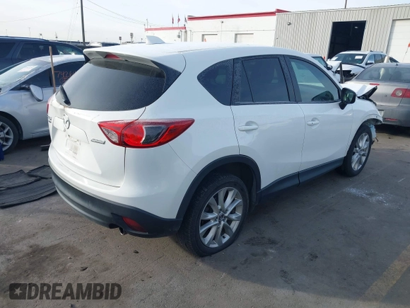 2015 Mazda CX-5 Grand Touring with VIN JM3KE4DY3F0483629, listed as a IAAI auction lot 41054059 with 118,980 mi miles. Bid and sale history available at carsss.com. Image 4.