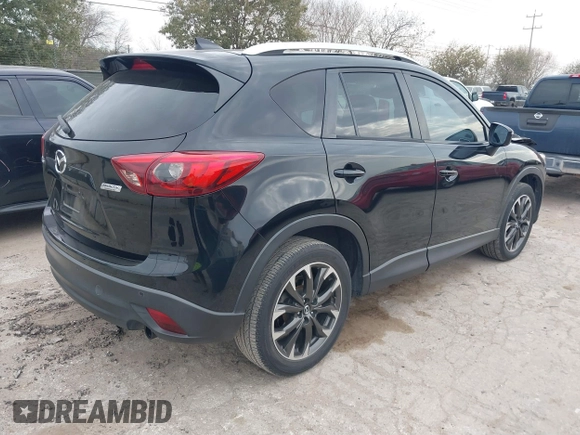 2016 Mazda CX-5 Grand Touring with VIN JM3KE2DY0G0651300, listed as a IAAI auction lot 41678833 with 98,790 mi miles. Bid and sale history available at carsss.com. Image 4.