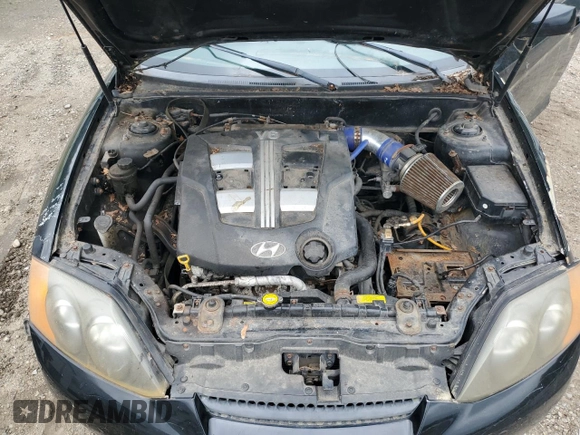2003 Hyundai Tiburon GT z VIN KMHHN65F83U101784, wystawiony jako Copart lot #41566805 z przebiegiem 99 970 mil mil oraz Nie do naprawy • Non repairable. Historia ofert i sprzedaży dostępna na DreamBid. Obrazek 11.