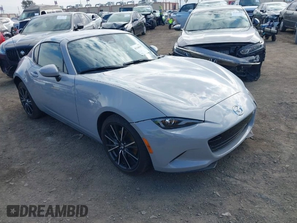 2024 Mazda MX-5 Miata Grand Touring z VIN JM1NDAM76R0602860, wystawiony jako IAAI lot #41346197 z przebiegiem 1 891 mil mil oraz . Historia ofert i sprzedaży dostępna na DreamBid. Obrazek 1.