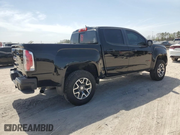 2021 GMC Canyon 4WD AT4 w/Leather with VIN 1GTG6FEN3M1274409, listed as a Copart auction lot 49228145 with 57,194 mi miles and Salvage Title. Bid and sale history available at carsss.com. Image 3.