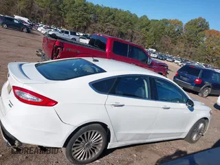 2016 Ford Fusion Titanium with VIN 3FA6P0K98GR150939, listed as a IAAI auction lot 40994523 with 144,051 mi miles. Bid and sale history available at carsss.com. Image 13.