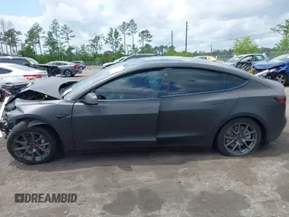 2022 Tesla Model 3 with VIN 5YJ3E1EA3NF287512, listed as a IAAI auction lot 42000557 with 77,619 mi miles. Bid and sale history available at carsss.com. Image 13.