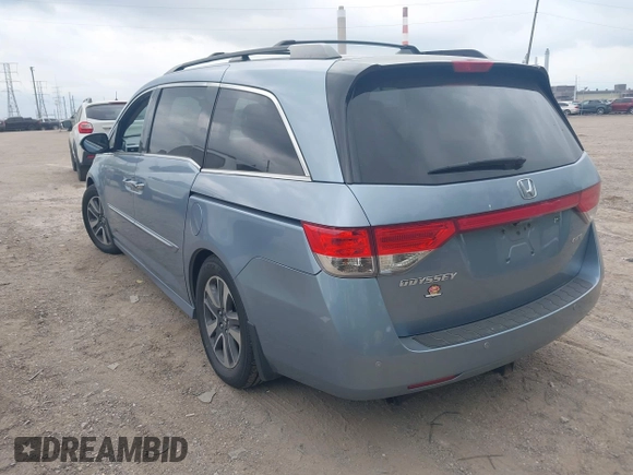 2014 Honda Odyssey Touring with VIN 5FNRL5H91EB081811, listed as a IAAI auction lot 42153920 with 16 mi miles and . Bid and sale history available at DreamBid. Image 3.