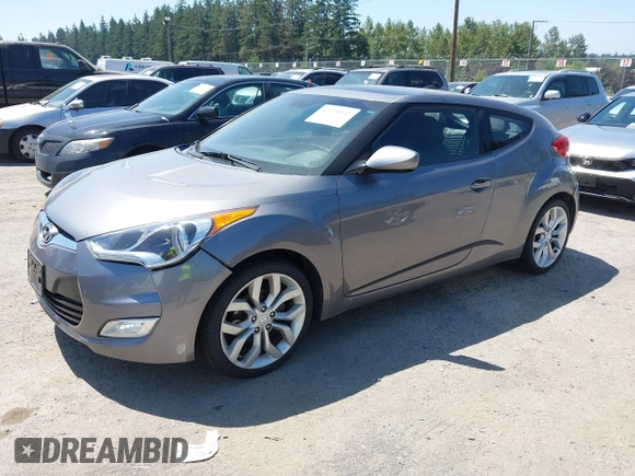 2012 Hyundai Veloster w/Black Int with VIN KMHTC6AD5CU030788, listed as a IAAI auction lot 42774337 with 104,297 mi miles and . Bid and sale history available at DreamBid. Image 2.