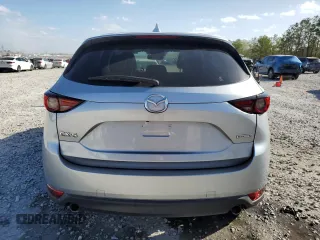 2021 Mazda CX-5 Grand Touring with VIN JM3KFADM8M1339008, listed as a Copart auction lot 49150115 with 144,851 mi miles and Salvage Title. Bid and sale history available at carsss.com. Image 6.