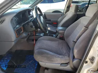 1996 Jeep Grand Cherokee Laredo with VIN 1J4FX58SXTC349575, listed as a Copart auction lot 80545584 with 302,636 mi miles and Salvage Title. Bid and sale history available at carsss.com. Image 7.