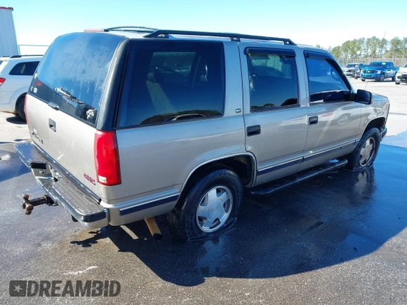 1998 GMC Yukon with VIN 1GKEK13R4WJ725608, listed as a IAAI auction lot 41596559 with 323,141 mi miles. Bid and sale history available at carsss.com. Image 4.