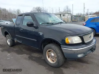 2000 Ford F-150 XL with VIN 1FTRX18WXYNC25817, listed as a IAAI auction lot 41976618 with 148,794 mi miles. Bid and sale history available at carsss.com. Image 1.