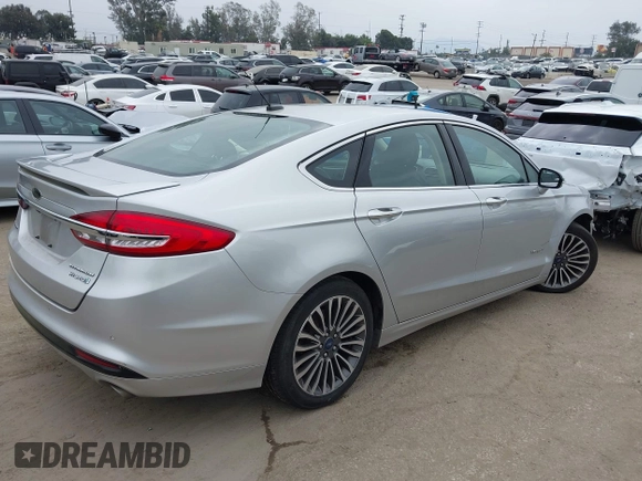2017 Ford Fusion Hybrid Titanium z VIN 3FA6P0RU7HR300311, wystawiony jako IAAI lot #42045664 z przebiegiem 136 231 mil mil oraz . Historia ofert i sprzedaży dostępna na DreamBid. Obrazek 4.