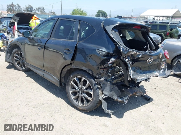 2016 Mazda CX-5 Grand Touring z VIN JM3KE2DY6G0900005, wystawiony jako IAAI lot #42311162 z przebiegiem 80 758 mil mil oraz . Historia ofert i sprzedaży dostępna na DreamBid. Obrazek 3.