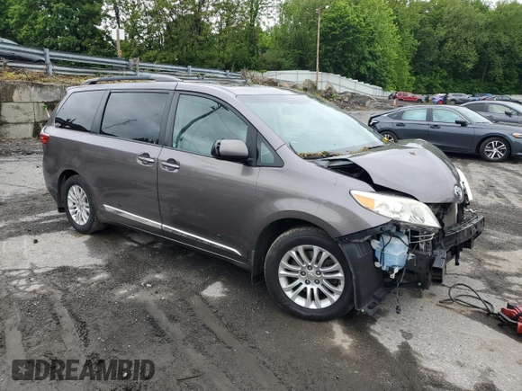 2015 Toyota Sienna XLE with VIN 5TDYK3DC4FS659692, listed as a Copart auction lot 57248355 with 121,644 mi miles and Salvage title. Bid and sale history available at DreamBid. Image 4.