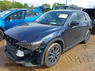 2018 Mazda CX-5 Grand Touring z VIN JM3KFADM8J1406007, wystawiony jako IAAI lot #42008567 z przebiegiem 110 661 mil mil oraz . Historia ofert i sprzedaży dostępna na DreamBid. Obrazek 17.