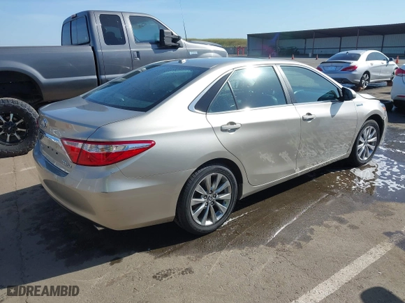 2015 Toyota Camry Hybrid LE with VIN 4T1BD1FK1FU174975, listed as a IAAI auction lot 42085034 with 54,728 mi miles. Bid and sale history available at carsss.com. Image 4.