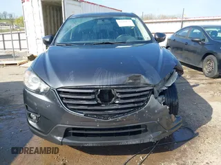 2016 Mazda CX-5 Touring with VIN JM3KE4CY3G0672977, listed as a IAAI auction lot 41889137 with 130,593 mi miles. Bid and sale history available at carsss.com. Image 13.