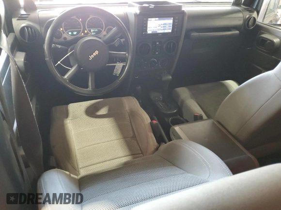 2007 Jeep Wrangler Unlimited Sahara с VIN 1J8GA591X7L217299, выставлен на аукционе Copart как лот 61984395 с пробегом 151 171 миль миль и Списание • Salvage title. История ставок и продаж доступна на DreamBid. Изображение 8.