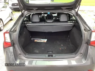 2021 Toyota Prius L Eco z VIN JTDKAMFU5M3141383, wystawiony jako IAAI lot #42529975 z przebiegiem 136 300 mil mil oraz . Historia ofert i sprzedaży dostępna na DreamBid. Obrazek 1.