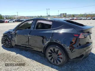 2022 Tesla Model Y Performance z VIN 7SAYGDEF0NF540933, wystawiony jako Copart lot #56087145 z przebiegiem 59 717 mil mil oraz Szkoda całkowita • Salvage title. Historia ofert i sprzedaży dostępna na DreamBid. Obrazek 2.