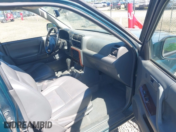 1998 Honda Passport LX z VIN 4S6CM58W0W4407344, wystawiony jako IAAI lot #42201105 z przebiegiem 254 317 mil mil oraz . Historia ofert i sprzedaży dostępna na DreamBid. Obrazek 5.