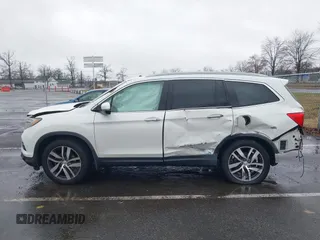 2016 Honda Pilot Touring with VIN 5FNYF6H95GB062089, listed as a IAAI auction lot 41810378 with 74,704 mi miles and . Bid and sale history available at DreamBid. Image 14.