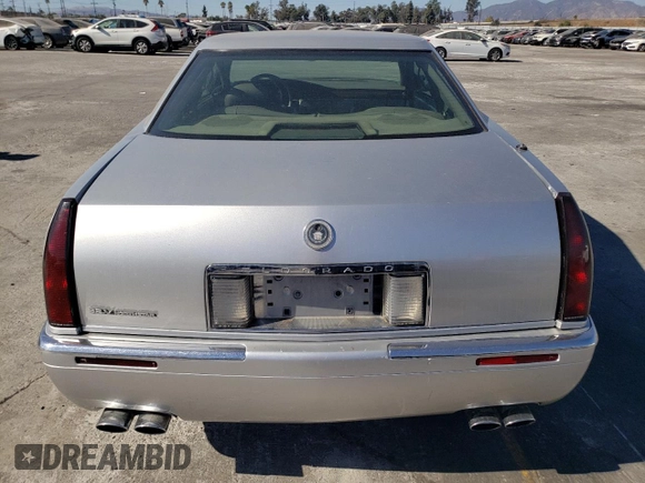 1999 Cadillac Eldorado z VIN 1G6EL12Y0XU604529, wystawiony jako Copart lot #77620004 z przebiegiem 246 032 mil mil oraz Szkoda całkowita • Salvage title. Historia ofert i sprzedaży dostępna na DreamBid. Obrazek 6.