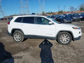 2015 Jeep Cherokee Latitude with VIN 1C4PJMCB3FW734573, listed as a IAAI auction lot 41825561 with 141,250 mi miles. Bid and sale history available at carsss.com. Image 14.