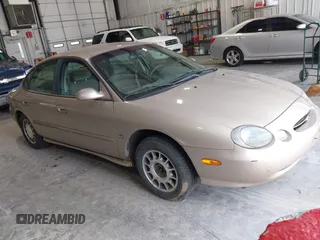 1999 Ford Taurus SE Comfort z VIN 1FAFP53S0XG145837, wystawiony jako IAAI lot #42384370 z przebiegiem 94 870 mil mil oraz . Historia ofert i sprzedaży dostępna na DreamBid. Obrazek 1.