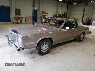 1984 Cadillac Eldorado z VIN 1G6AL5786EE661663, wystawiony jako Copart lot #58465615 z przebiegiem 36 554 mil mil oraz Czysty tytuł • Clean title. Historia ofert i sprzedaży dostępna na DreamBid. Obrazek 1.