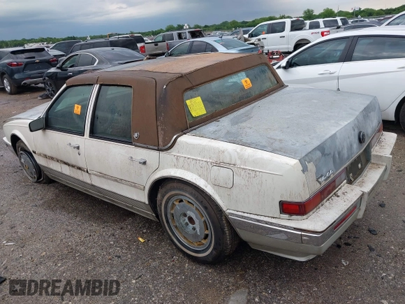 1990 Cadillac Seville z VIN 1G6KY533XLU803161, wystawiony jako IAAI lot #42164352 z przebiegiem Nie podano mil oraz . Historia ofert i sprzedaży dostępna na DreamBid. Obrazek 3.