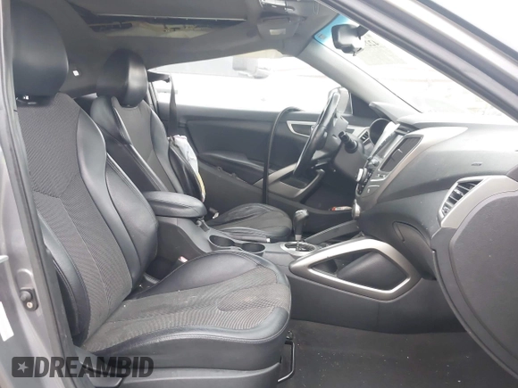 2012 Hyundai Veloster w/Gray Int z VIN KMHTC6AD3CU069427, wystawiony jako IAAI lot #42292476 z przebiegiem 166 960 mil mil oraz . Historia ofert i sprzedaży dostępna na DreamBid. Obrazek 5.