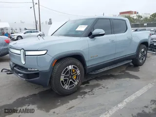 2023 Rivian R1T Launch Edition with VIN 7FCTGAAL3PN017339, listed as a IAAI auction lot 42041423 with 15,098 mi miles. Bid and sale history available at carsss.com. Image 21.