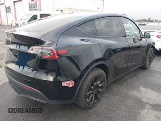 2023 Tesla Model Y Long Range with VIN 7SAYGDEE2PA024032, listed as a IAAI auction lot 41213403 with 23,418 mi miles and . Bid and sale history available at DreamBid. Image 4.