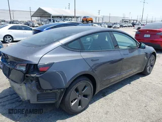 2023 Tesla Model 3 with VIN 5YJ3E1EA4PF400306, listed as a IAAI auction lot 42398603 with 18,551 mi miles and . Bid and sale history available at DreamBid. Image 4.