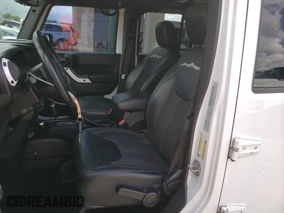 2015 Jeep Wrangler Unlimited Wrangler X with VIN 1C4BJWEG6FL614671, listed as a Copart auction lot 62286095 with 94,928 mi miles and Salvage title. Bid and sale history available at DreamBid. Image 7.