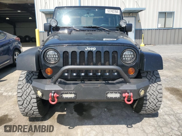 2011 Jeep Wrangler Sahara with VIN 1J4AA5D14BL542912, listed as a Copart auction lot 65158784 with 122,795 mi miles and Salvage Title. Bid and sale history available at DreamBid. Image 5.
