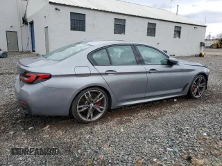 2023 BMW 5 Series M550i xDrive with VIN WBA13BK06PCN02733, listed as a Copart auction lot 48767235 with 27,725 mi miles and Salvage title. Bid and sale history available at DreamBid. Image 3.