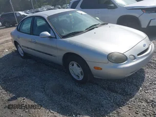 1997 Ford Taurus GL z VIN 1FALP52U9VA295404, wystawiony jako IAAI lot #42234839 z przebiegiem 163 080 mil mil oraz . Historia ofert i sprzedaży dostępna na DreamBid. Obrazek 1.