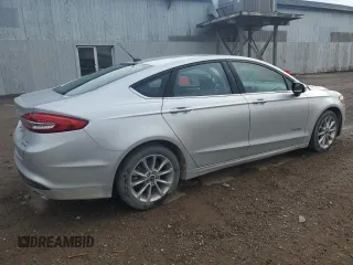 2017 Ford Fusion Hybrid SE z VIN 3FA6P0LU4HR384645, wystawiony jako Copart lot #56454995 z przebiegiem 165 322 mil mil oraz Czysty tytuł • Clean title. Historia ofert i sprzedaży dostępna na DreamBid. Obrazek 3.
