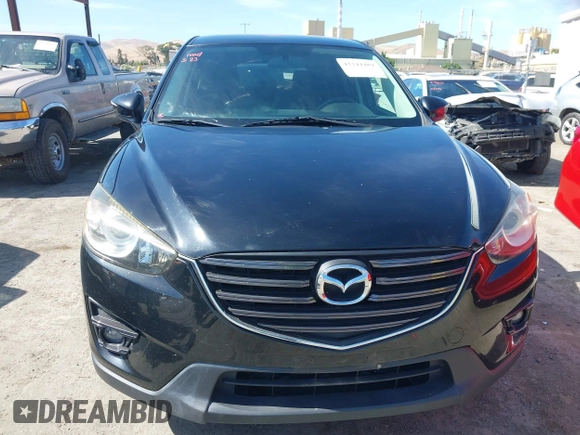 2016 Mazda CX-5 Touring z VIN JM3KE4CY2G0656270, wystawiony jako IAAI lot #42344489 z przebiegiem 60 449 mil mil oraz . Historia ofert i sprzedaży dostępna na DreamBid. Obrazek 13.