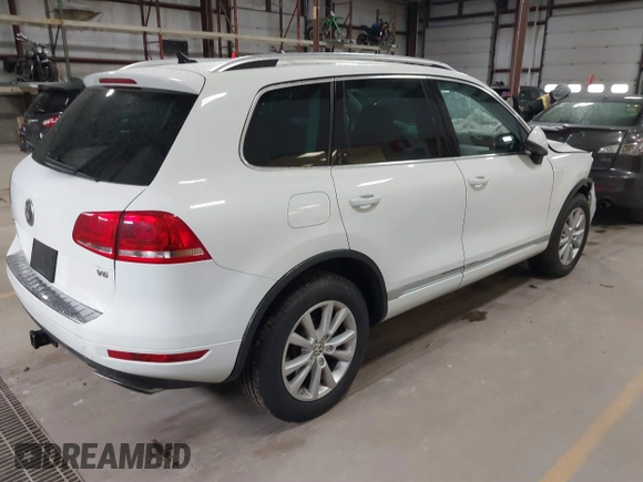 2014 Volkswagen Touareg Sport with VIN WVGEF9BP6ED005007, listed as a IAAI auction lot 41757033 with Not Provided miles and . Bid and sale history available at DreamBid. Image 4.
