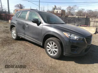 2016 Mazda CX-5 Sport with VIN JM3KE4BY1G0801879, listed as a IAAI auction lot 41795712 with 57,245 mi miles and . Bid and sale history available at DreamBid. Image 1.